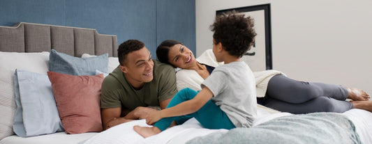 Family lying in bed