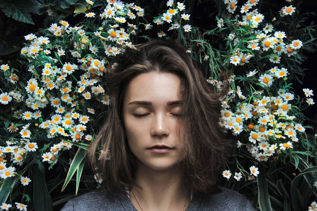 woman sleeping with a semi-circle of flowers around her head