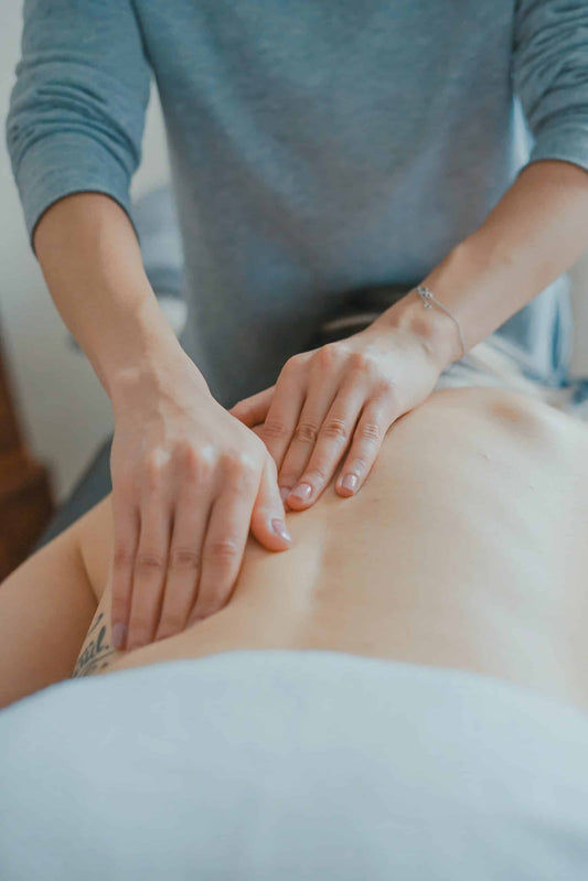 Image of hands on a person's back giving a massage