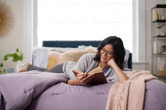 Woman reading a book in bed